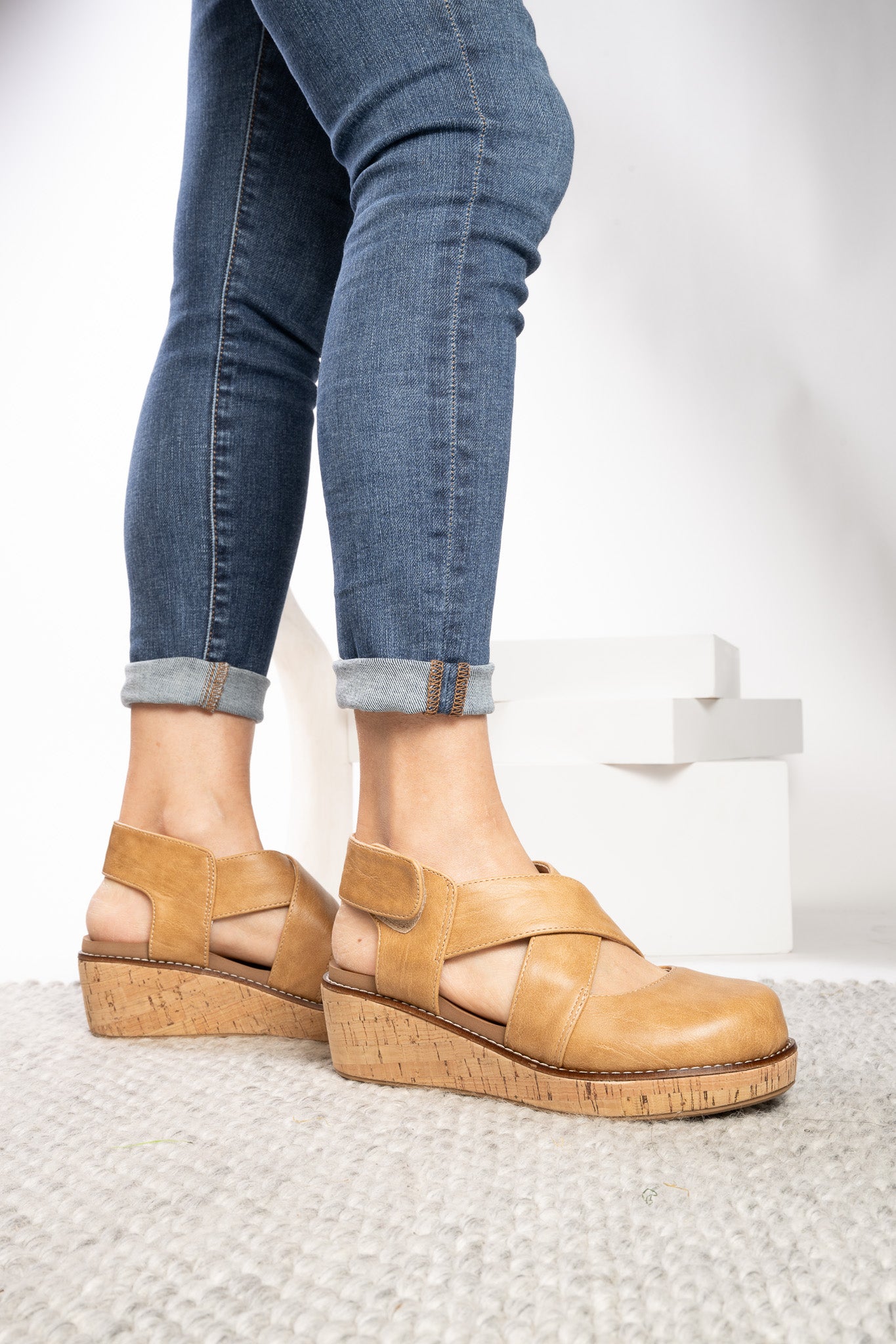 Corkys Bring It In caramel closed toe wedge shoes with crisscross straps and cork-inspired sole.