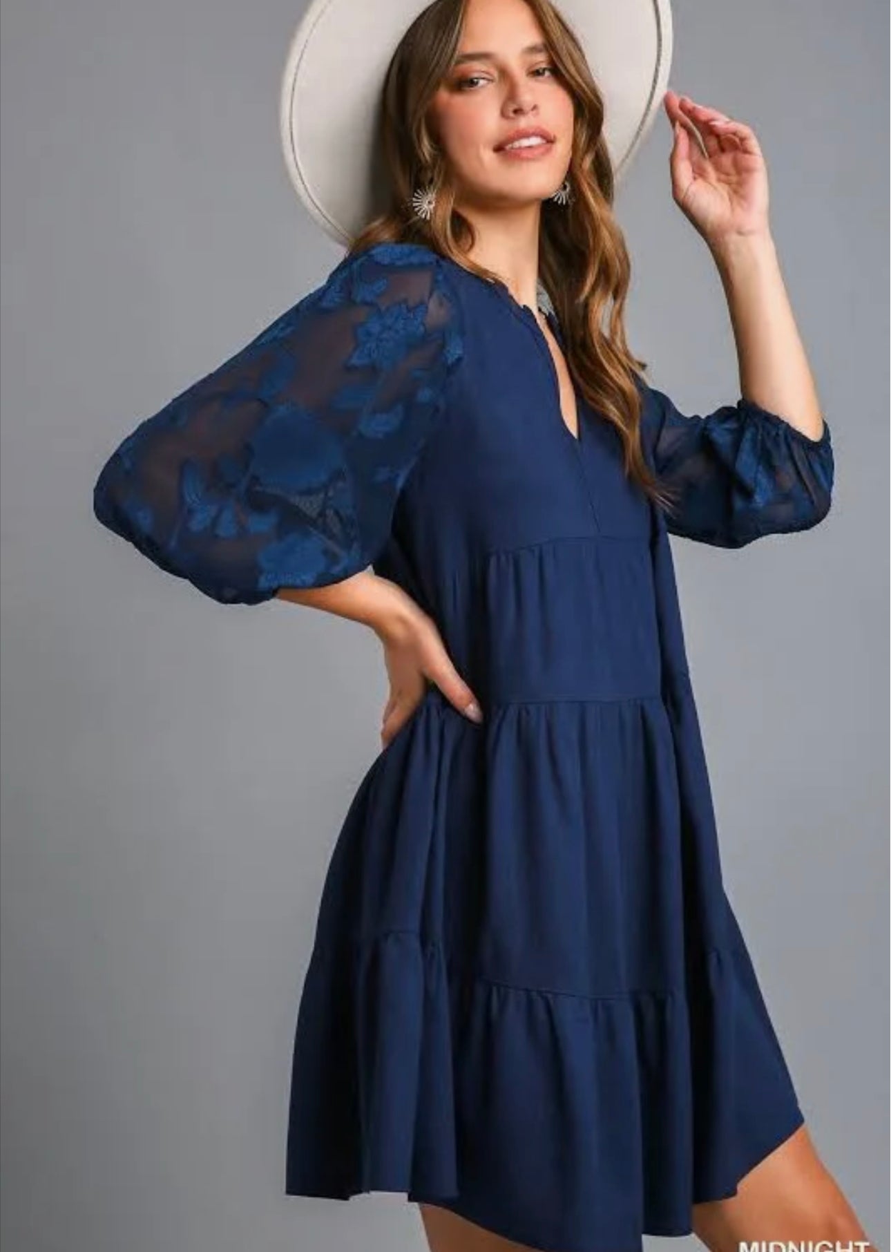 Women’s navy tiered mini dress with sheer floral three-quarter sleeves and split V-neckline