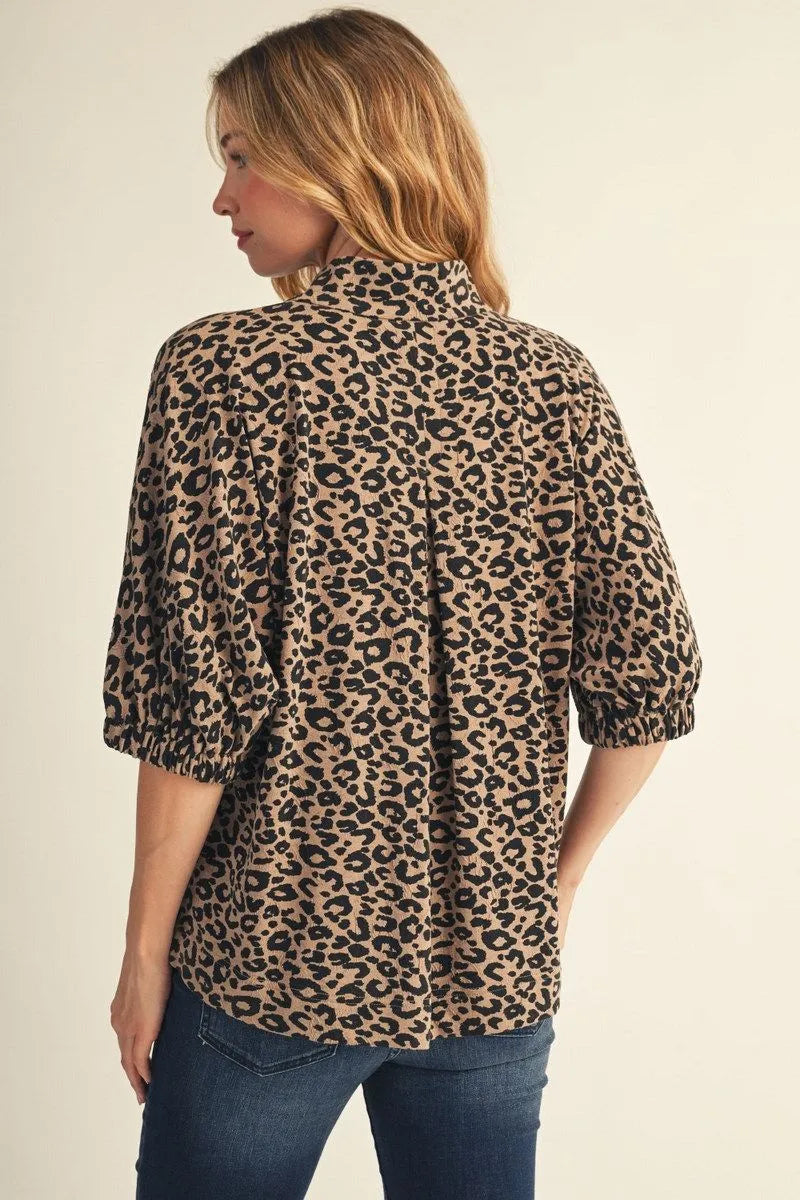 Back of leopard print blouse featuring relaxed fit, half sleeves and elastic cuffs