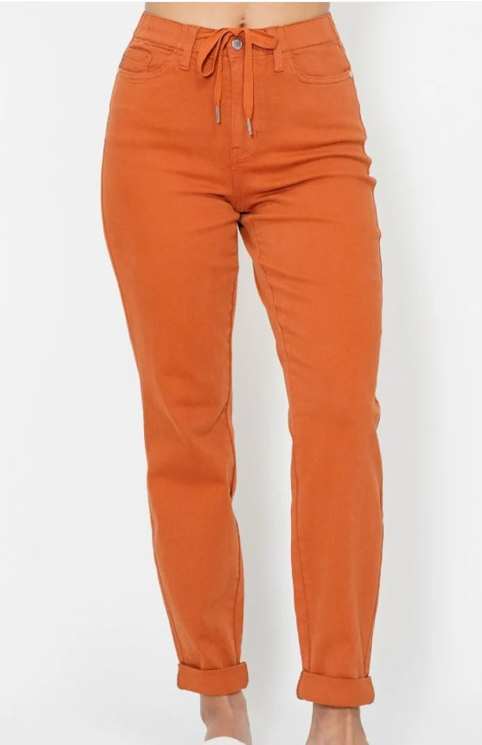 Close-up of orange Judy Blue joggers showing the tie waist, front pockets and cuffed hems
