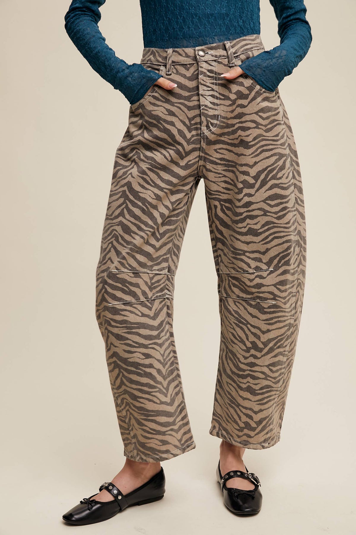 Front view of taupe and brown zebra print barrel jeans with a high waist and curved legs.