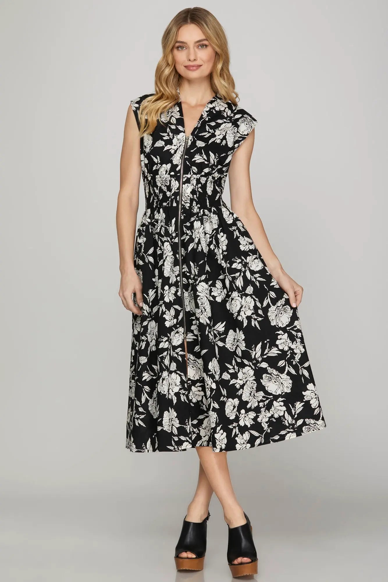 Black and ivory floral midi dress with front zipper, smocked waist, cap sleeves and pockets