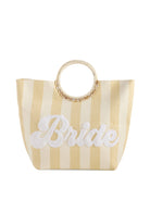  striped tote bag with round woven handles and “Bride” in white script across the front, perfect for weddings or bachelorette trips.