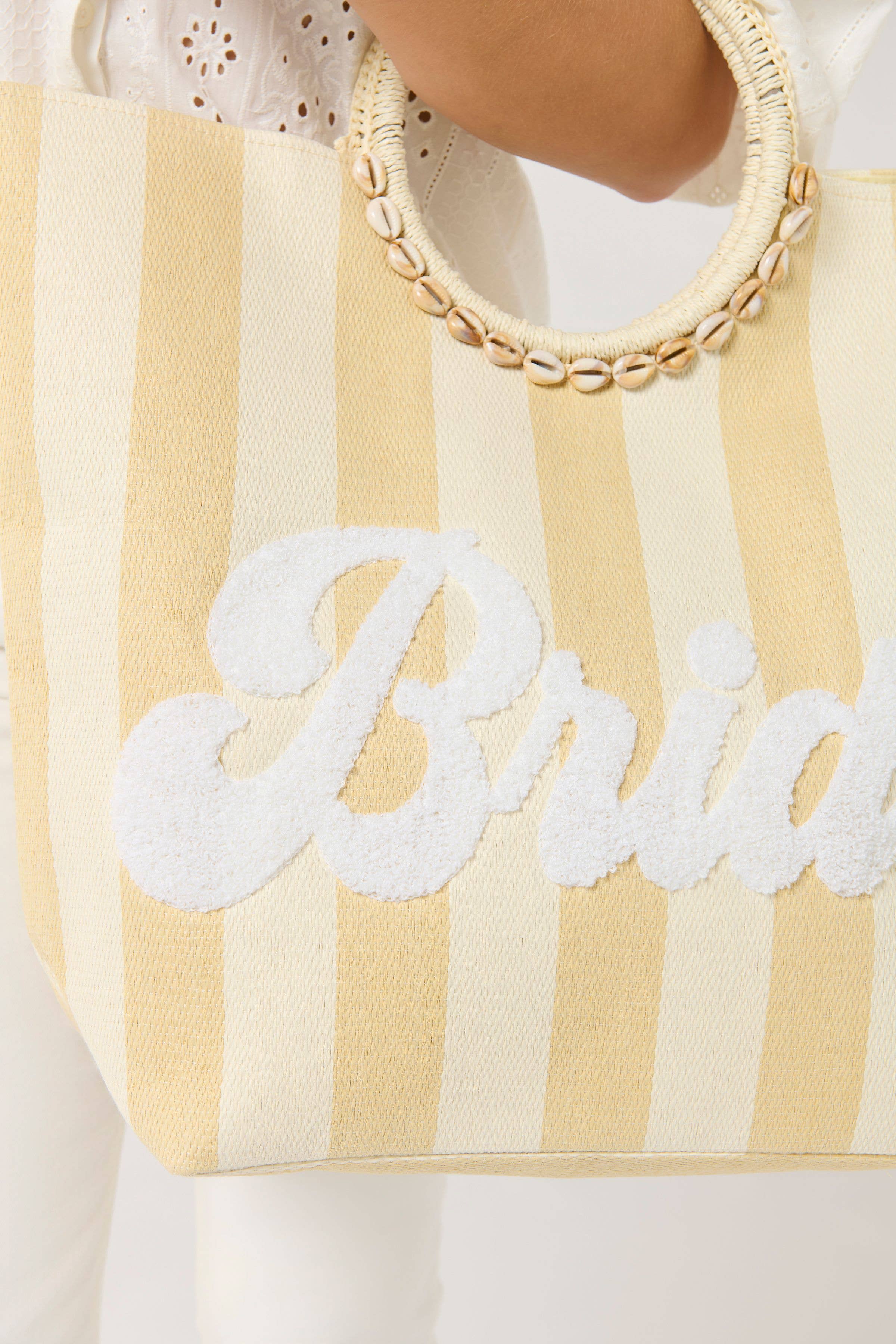 striped beach tote with circular woven handles and bold white “Bride” lettering on the front—perfect for bridal showers, honeymoon travel, or poolside essentials.