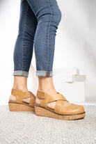 Corkys Bring It In caramel closed toe wedge shoes with crisscross straps and cork-inspired sole.