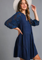 Women’s navy tiered mini dress with sheer floral three-quarter sleeves and split V-neckline
