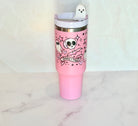Pink 40 oz Spooky Vibes Halloween tumbler with ghost and skull design, lid, clear straw, and white ghost straw topper.