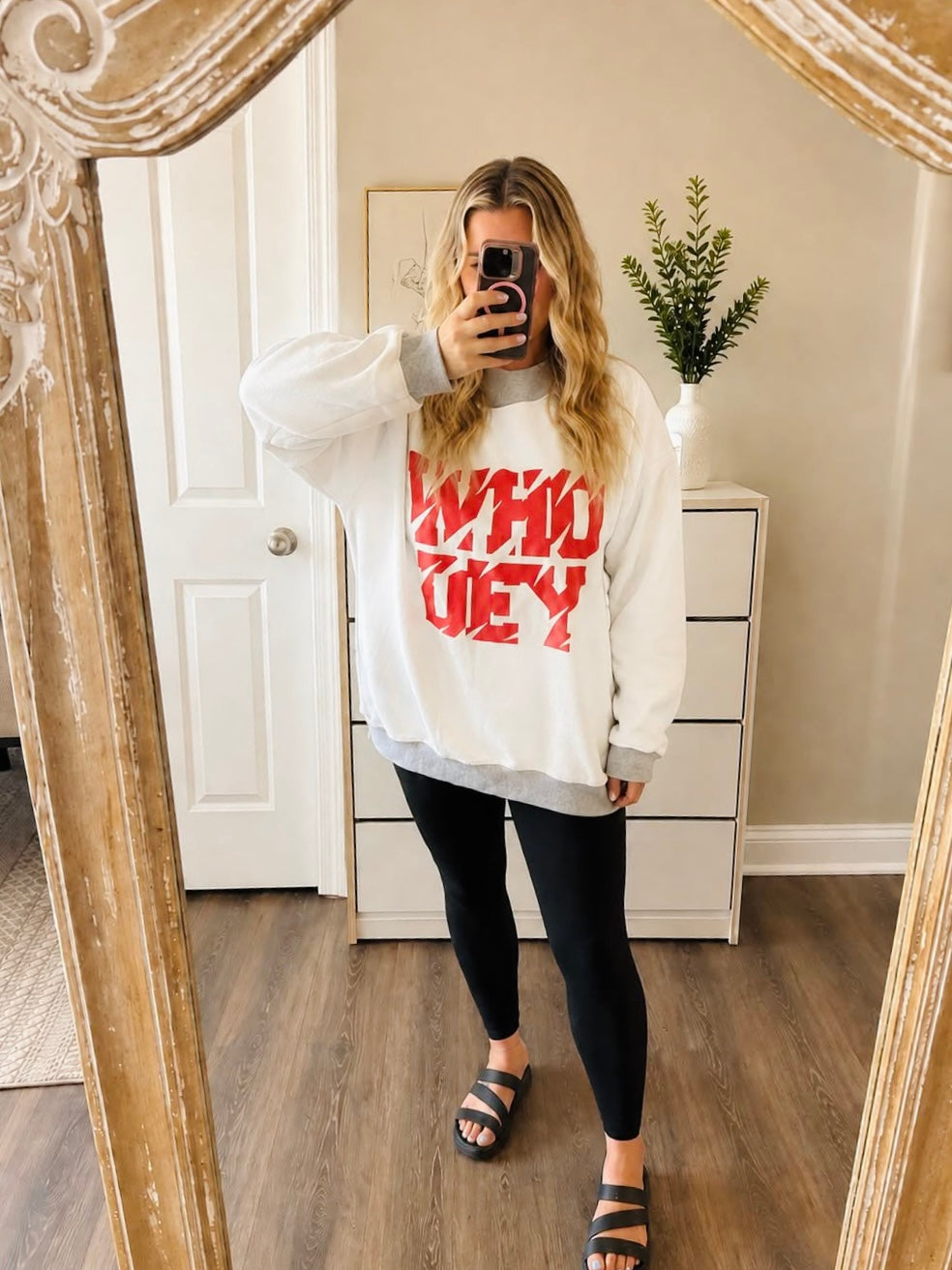White reverse side of Bengals mock neck sweatshirt featuring red WHO DEY graphic styled with black leggings