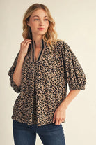 Leopard print women's top with standing collar, contrast ribbed trim and front pleat detail
