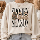 Cream Spooky Season Halloween sweatshirt with camo, leopard and checkered ghost graphic