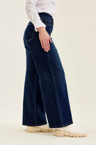 Angled front view of Judy Blue high waist wide leg jeans in dark indigo denim