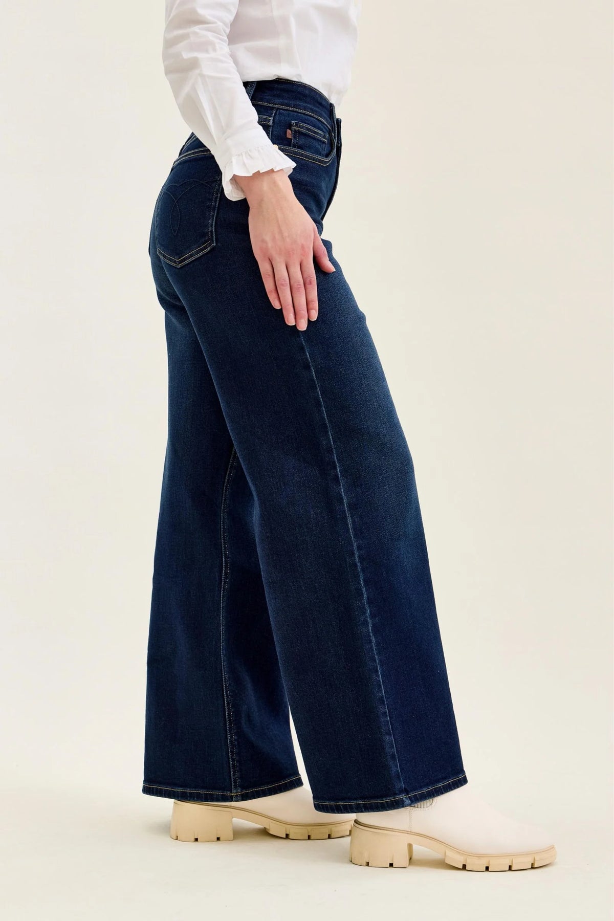 Side view of Judy Blue petite wide leg jeans showing the silhouette and finished hems