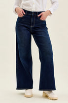 Angled front view of Judy Blue high waist wide leg jeans in dark indigo denim