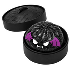 Black glittery bat dumpling with purple bat wings and white teeth inside a black steamer container