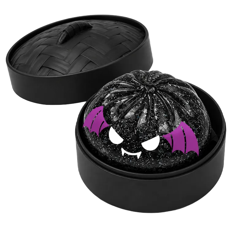Black glittery bat dumpling with purple bat wings and white teeth inside a black steamer container