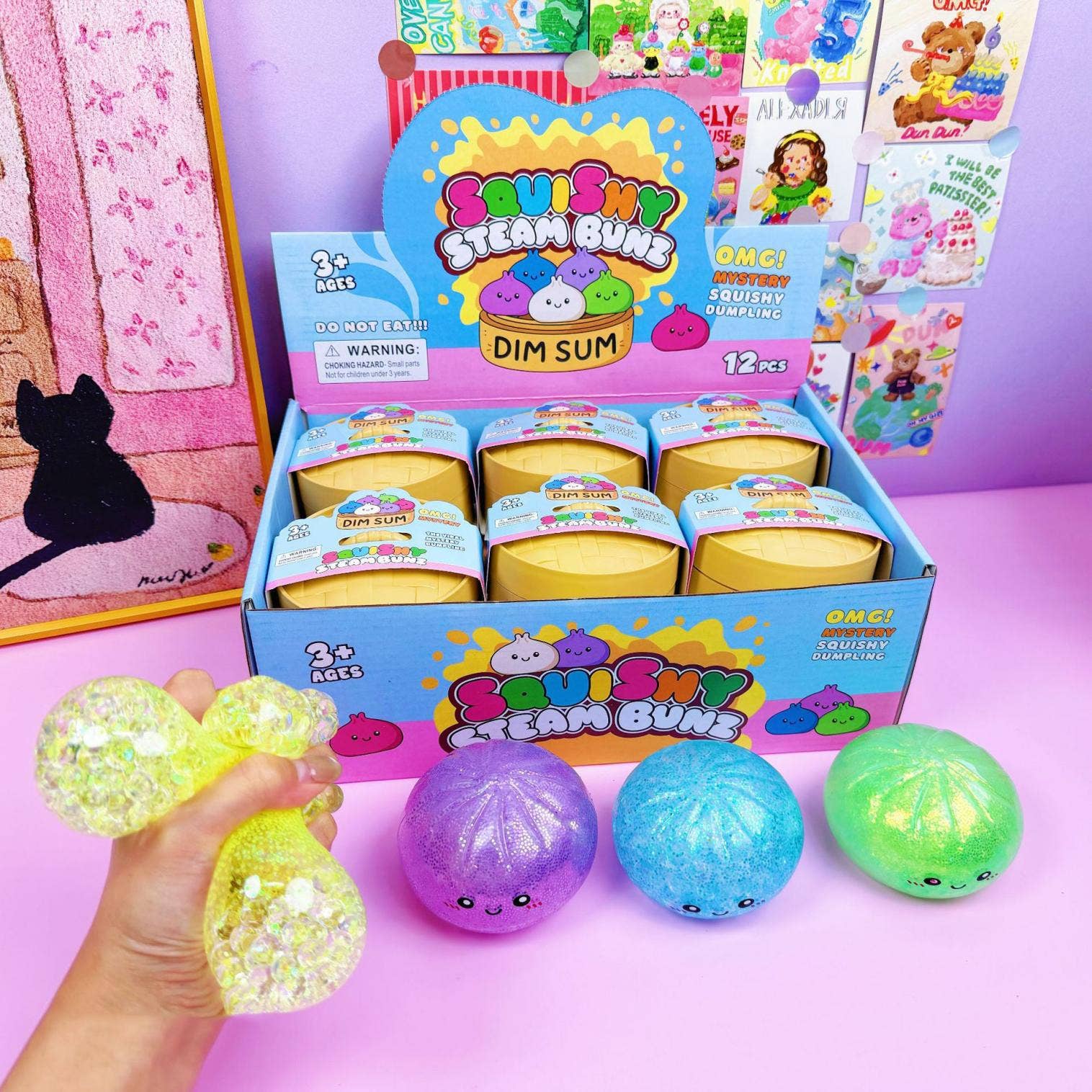 Display of 'Bouncy Steam Buns' with colorful buns and packaging on a pink background.