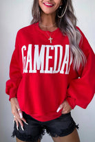 Person wearing a red sweatshirt with 'GAMEDAY' text