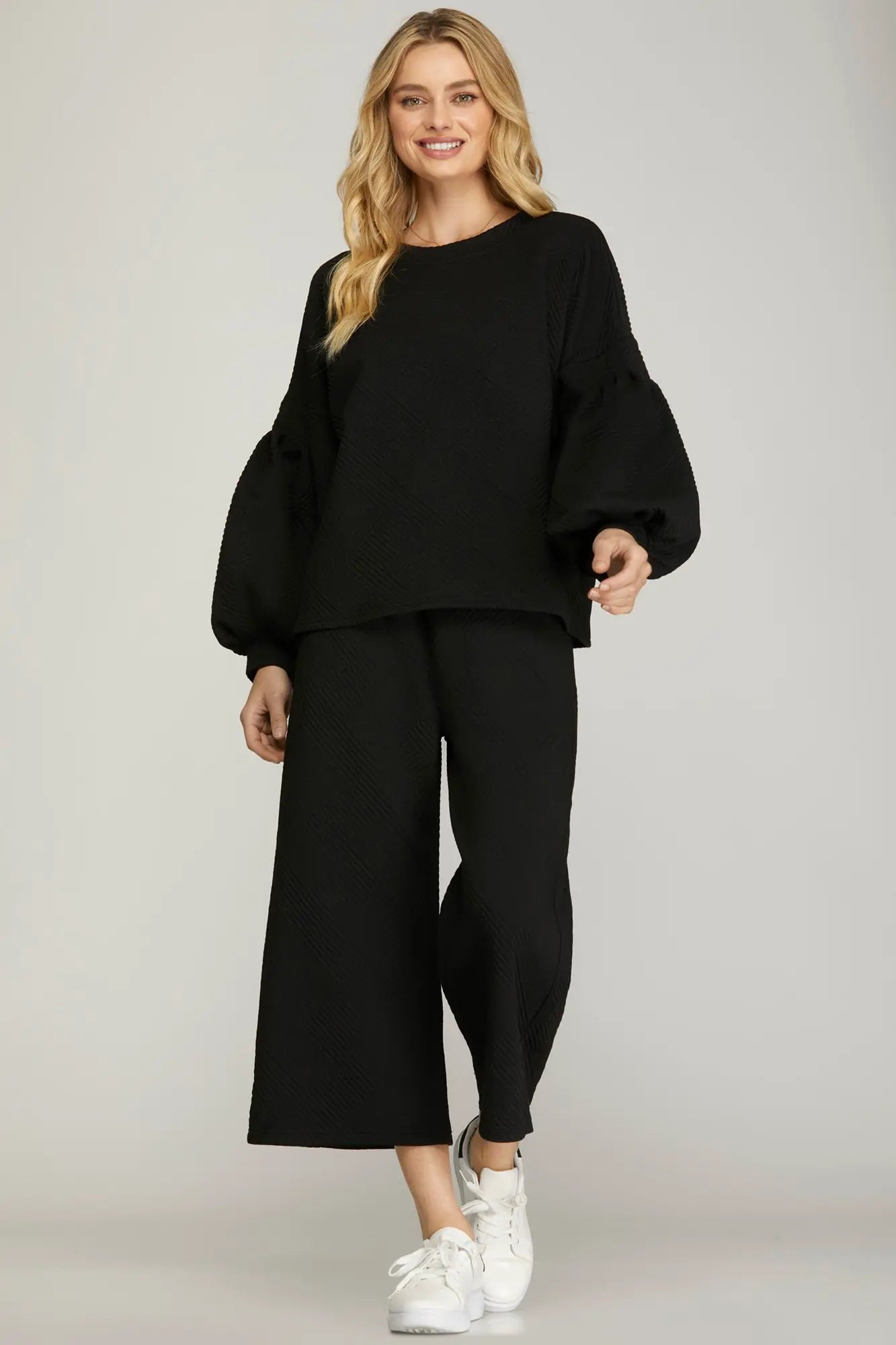 Women’s black textured cropped wide-leg pants featuring a comfortable pull-on waistband and relaxed fit. Versatile casual pants perfect for travel, work, weekend outings, and everyday wear.